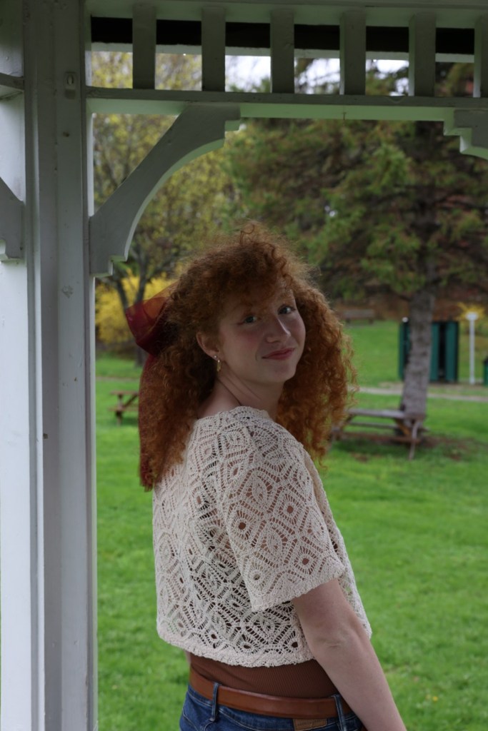 Photo of girl with curly red hair looking into the camera