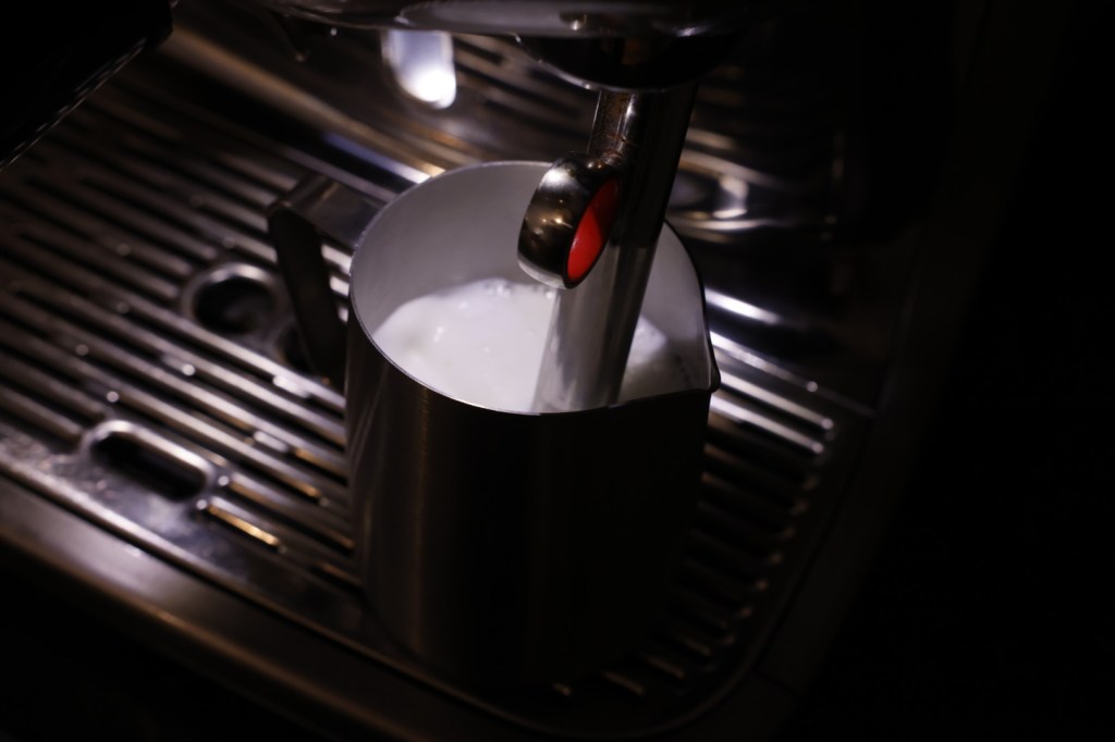 Image of milk being steamed in a stainless steel container