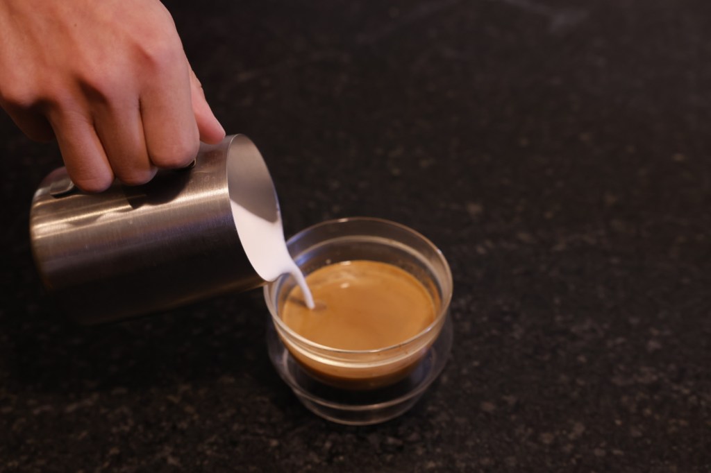 Image of milk being poured into coffee