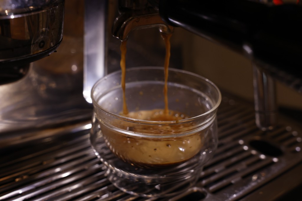 Image of coffee being poured from an espresso machine